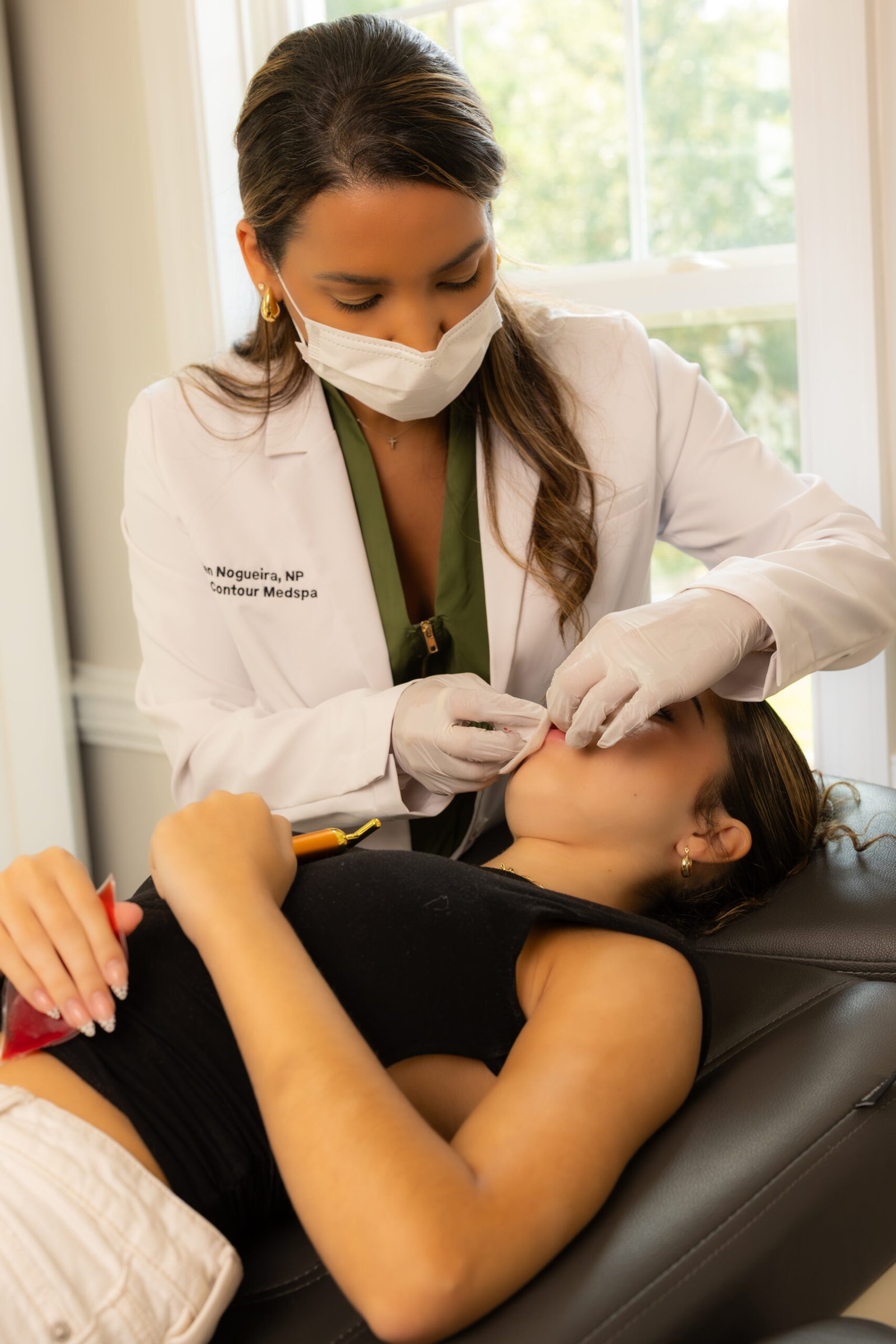 Ellen Nogueira providing an aesthetic treatment at Casa Contour MedSpa and Wellness in Virginia Beach
